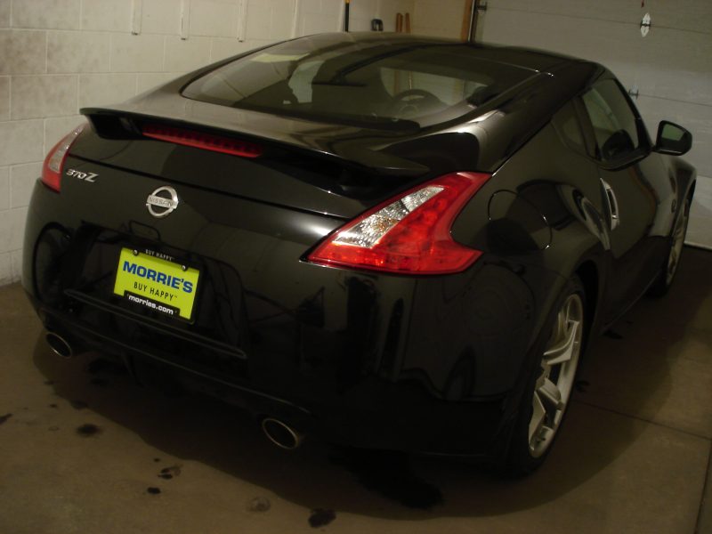 My Z arrived on 4-14-2011. Went to the dealership today, 4-15-2011, signed the papers, and brought it home. It was raining/snowing outside so I had to park it in the garage and wipe down the rain/snow water. I could only photograph the rear as there wasn't enough room in the front to take a photo.