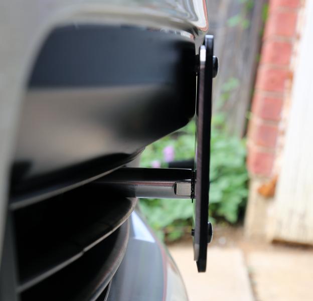 Side view.  The plate is not touching the bumper.  Only the two clear rubber pads are in contact with the bumper's black trim.