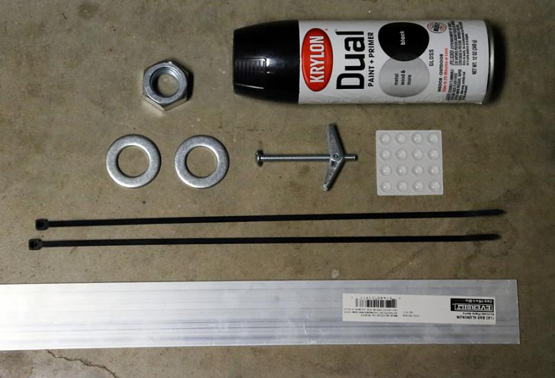 Materials used besides the Moweraxle bracket kit.  Black spray paint, aluminum bar for bracket, strong zip ties, 22mm washers, 24mm hex nut, strong wall anchor and adhesive clear rubber chair leg pads.