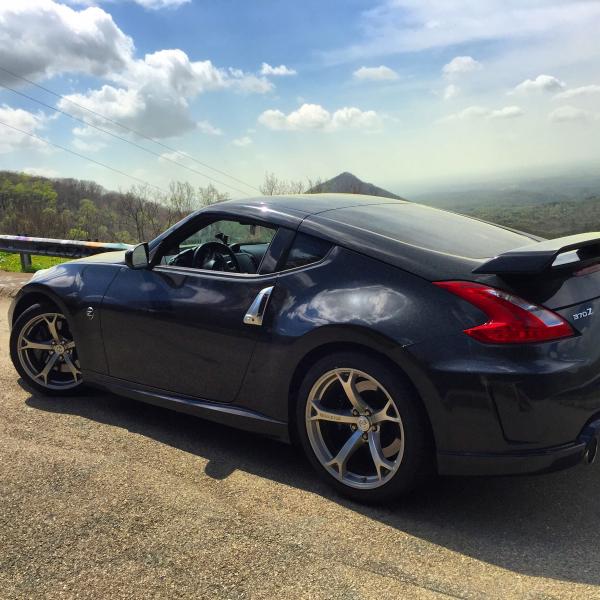 Light layer of pollen covering the beautiful Nismo Z parked over looking mountains.