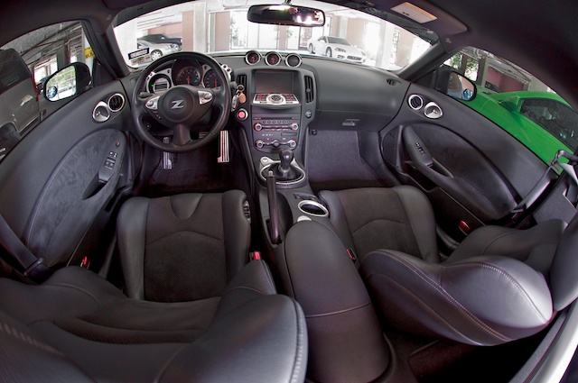 Cant forget the interior shot. love these, gotta have that fisheye! My (now neglected) 3KGT is in the photo along with my chicks synergy green Camaro and you can see me in the rearview, all unintentional. It's amazing how dirty it looks after taking some time cleaning it, mainly missed the door panels they need a quick swipe from the Vac. Put it in 4th so you can see more detail on the top of the knob, keys hangin on the air vent.