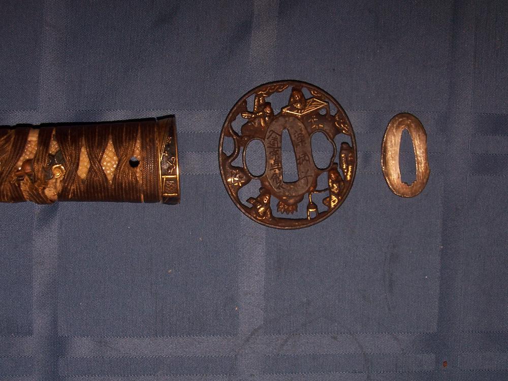 Gold inlaid tsuba. Inscribed with makers marks and to whom this was presented.With silver spacers too. High end fittings. Sadly missing kashira, end cap, one minuki, and scabbard drag tip. Handle needs new wrap but stingray skin is fine.