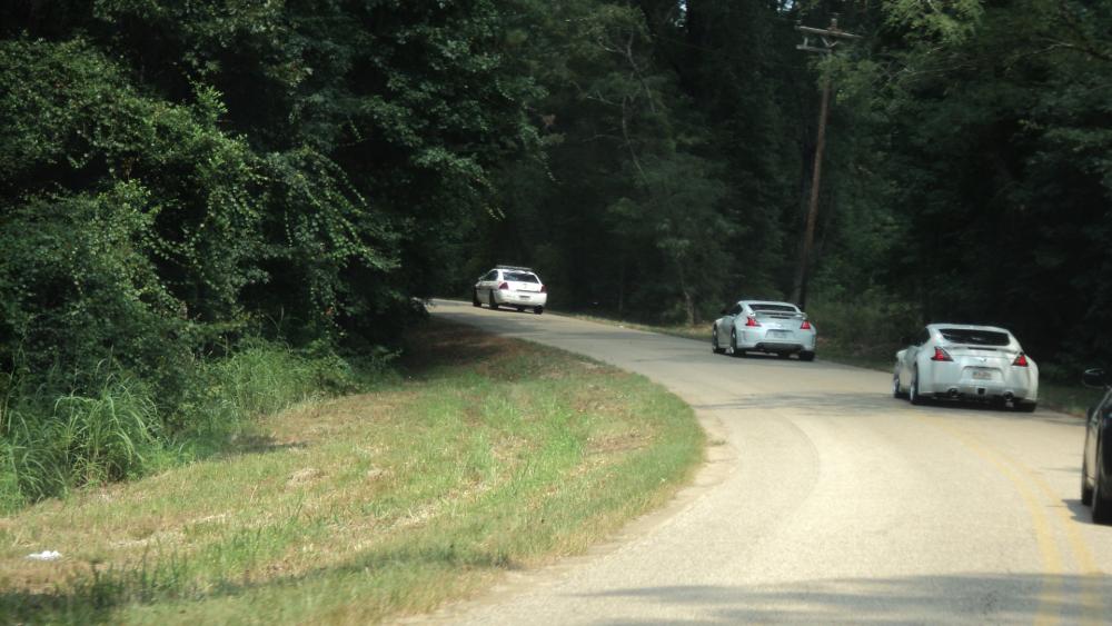 Is that a Cop escorting us? Or is he after Bucketman and TypeOne? Did Bucketman wake up the Cop when going around the bend and spraying gravel all over the cop's car, thereby waking him up from his afternoon nap? Stay Tuned for our next Episode: The Bucket Stops Here! or Can a Z drive at 15mph in 6th gear?