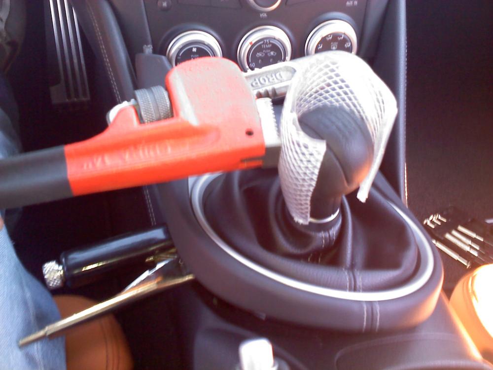 Step 3: Use a pipe wrench to unscrew the shifter, using the tubing to protect the leather finish, while holding the vice grip. This prevents twisting of the linkage.