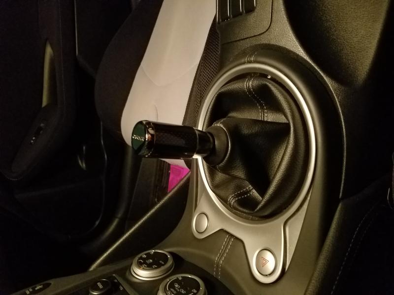 Nismo Carbon Fiber Shift knob.

The knob would not engage the screw with the finisher under the leather boot as intended.  The plastic grommit that holds the leather tabs keeping the boot snug sits on top of the finisher.  Eeerks me.