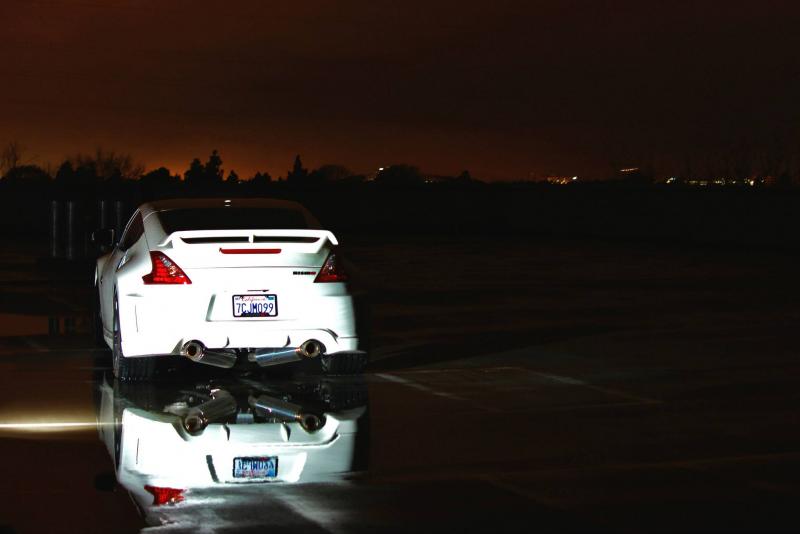 Fast intentions exhaust reflection with custom painted nismo badging.
