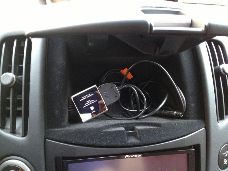 iPod wired adapter through cubby hole.